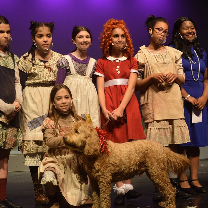 Annie and orphans holding the dog Sandy